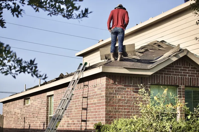 Professional roofer working on a residential roof in Wallpack Center